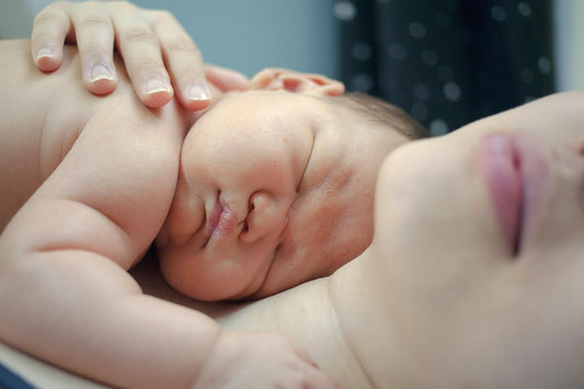 mum laying with newborn on chest skin to skin contact with newborn