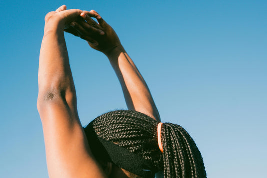 lady stretching her hands up above head
